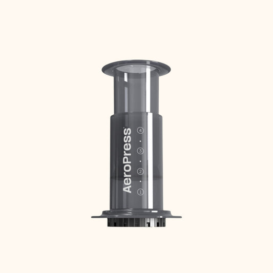 Kirjalan Paahtimo AeroPress Original -kahvinkeitin, jossa on läpinäkyvä harmaa muovirunko ja selkeät mittamerkinnät.